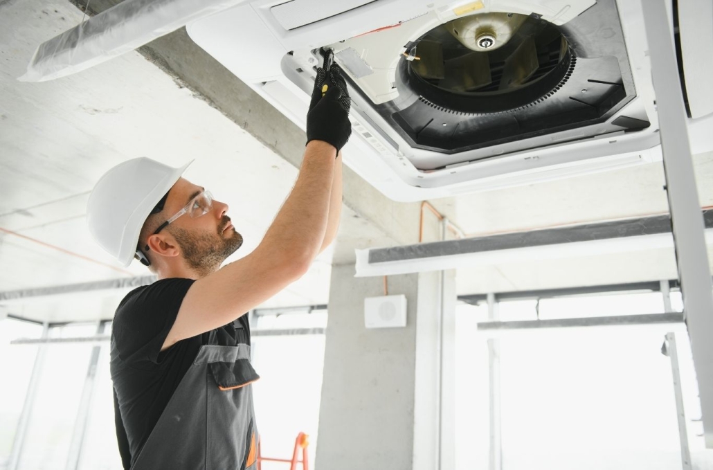 Skilled HVAC technician inspecting condenser and measuring system performance outdoors