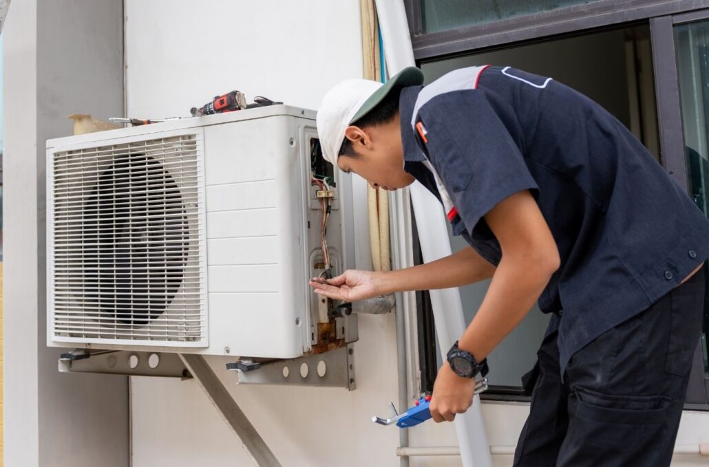 HVAC specialist inspecting air handler components for precise system performance. HVAC Contractor Near Me.