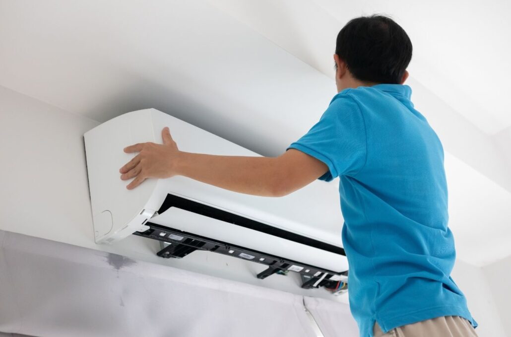 Experienced AC technician testing electrical components during urgent cooling system repair. AC Repair near me.