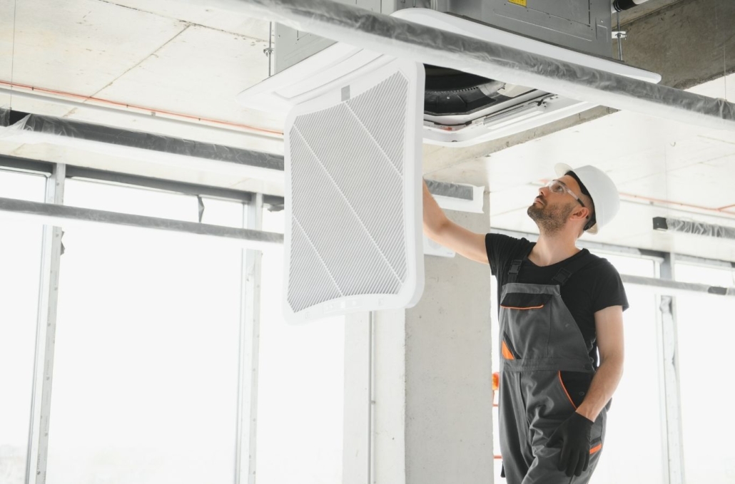 Technician diagnosing failed air conditioner at Indiantown home during extreme afternoon heat